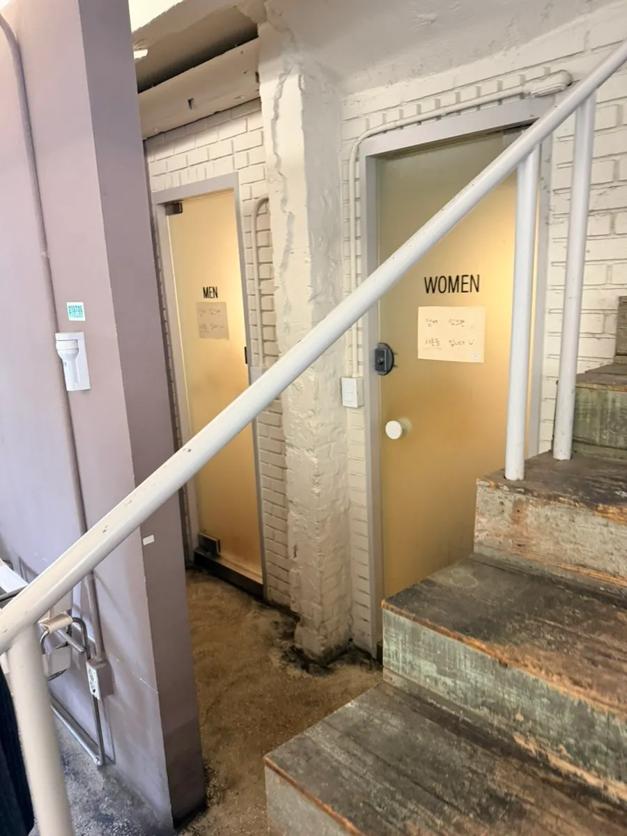 1st-floor hallway with restroom next to the stairs