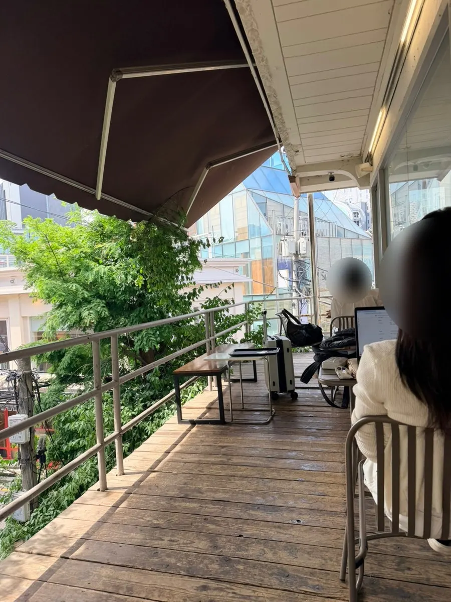 2nd-floor terrace with a big tree visible