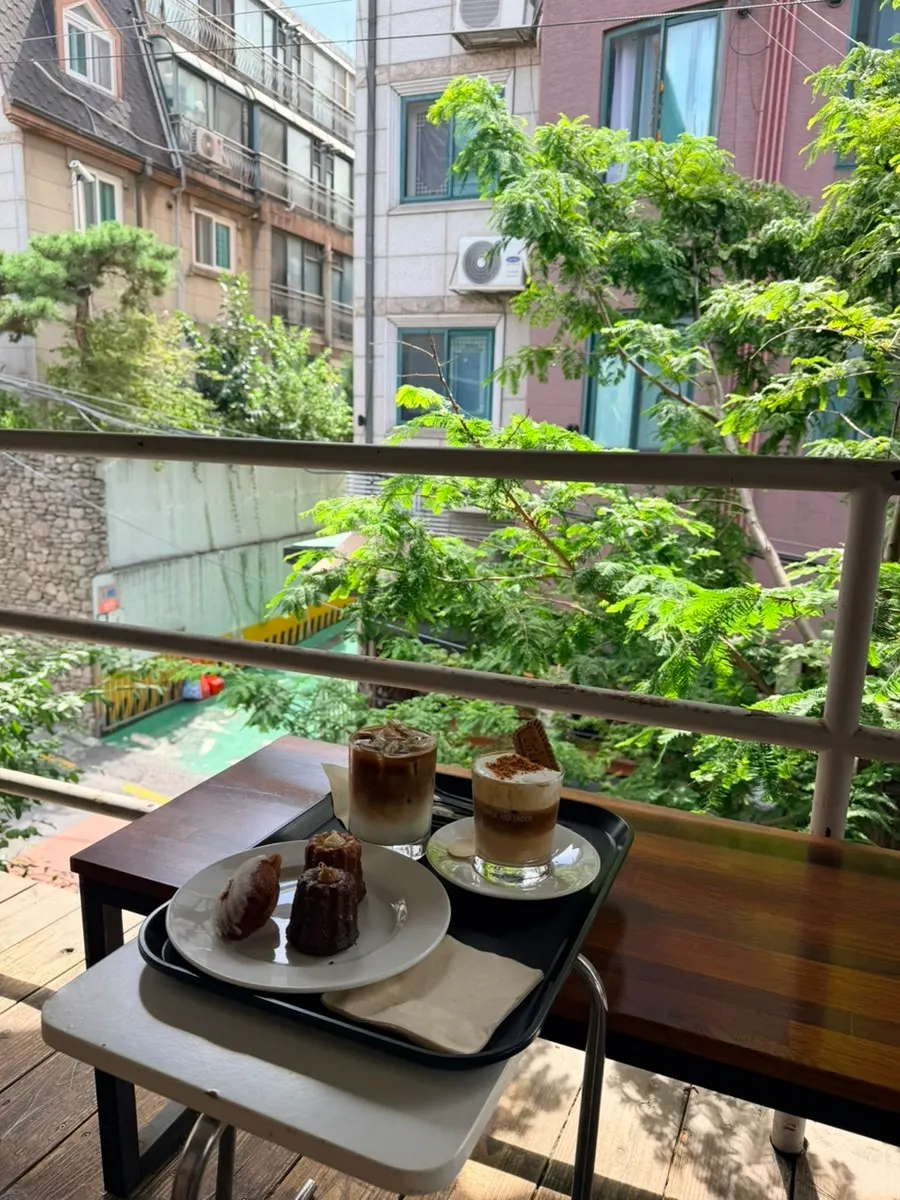 Drink and canelé set on the terrace table