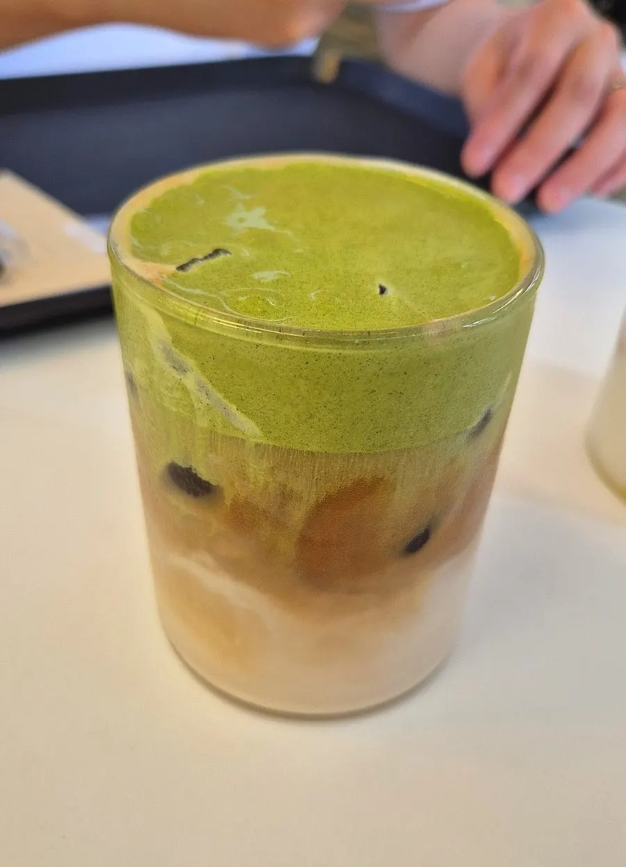 Matcha cream oat latte topped with matcha cream