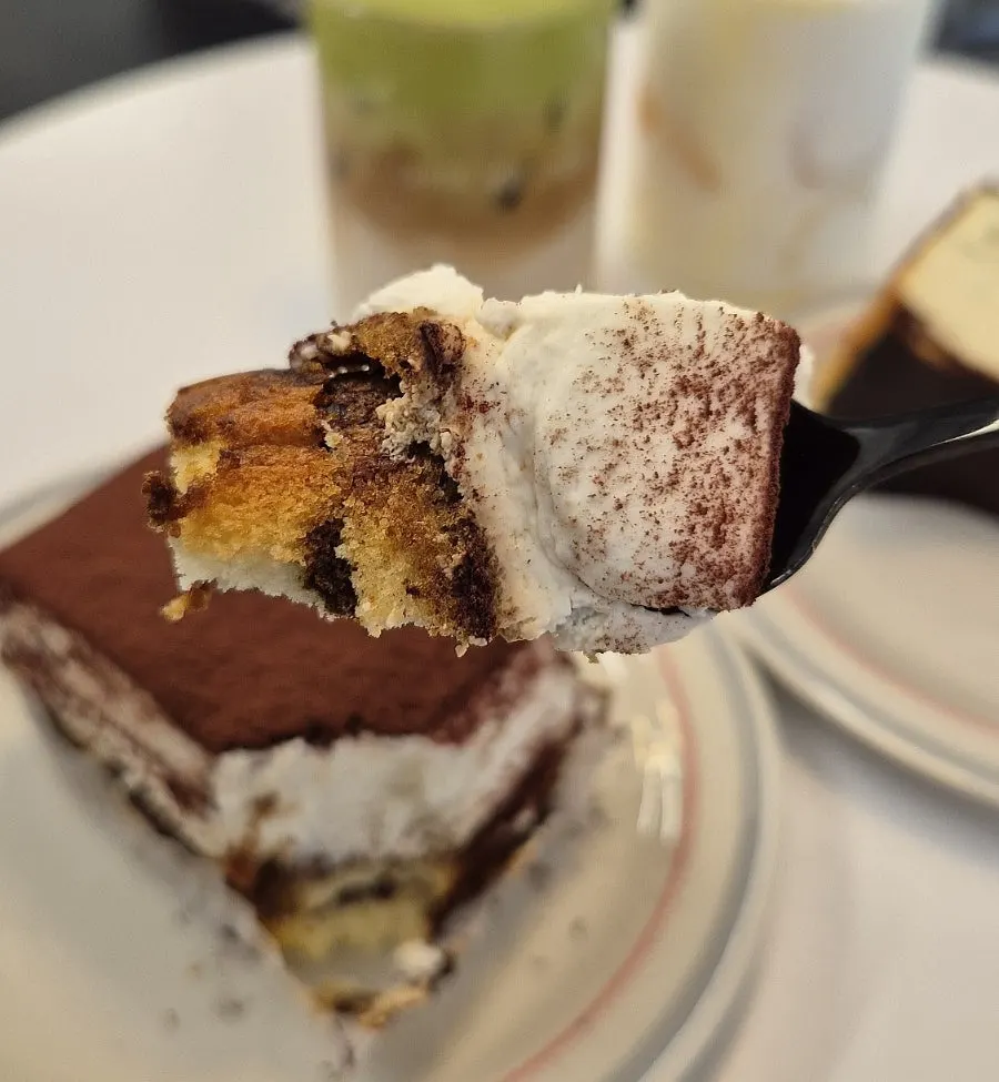 Table of desserts and drinks shared between two people