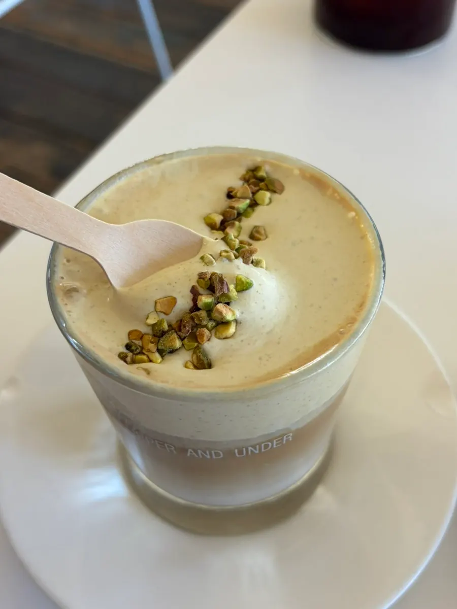 Pistachio cream latte showing its cream layer
