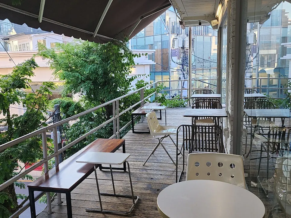 Café seat with green trees visible outside the window