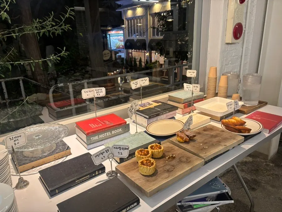 Display case with a variety of pastries next to a water station