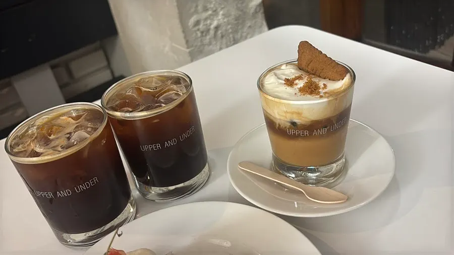 An iced americano and two cream lattes