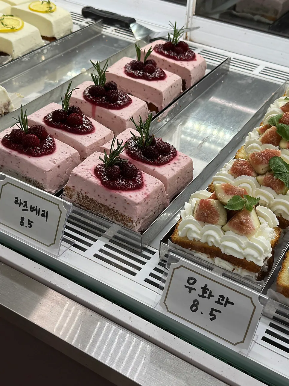 Tiramisu and lemon raspberry cake on display