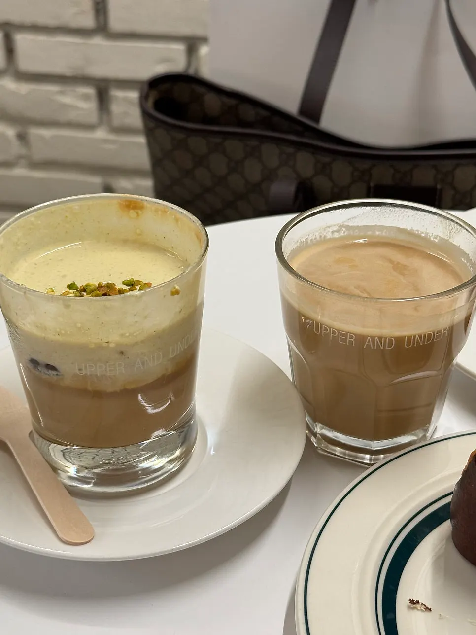 Pistachio cream latte and flat white side by side