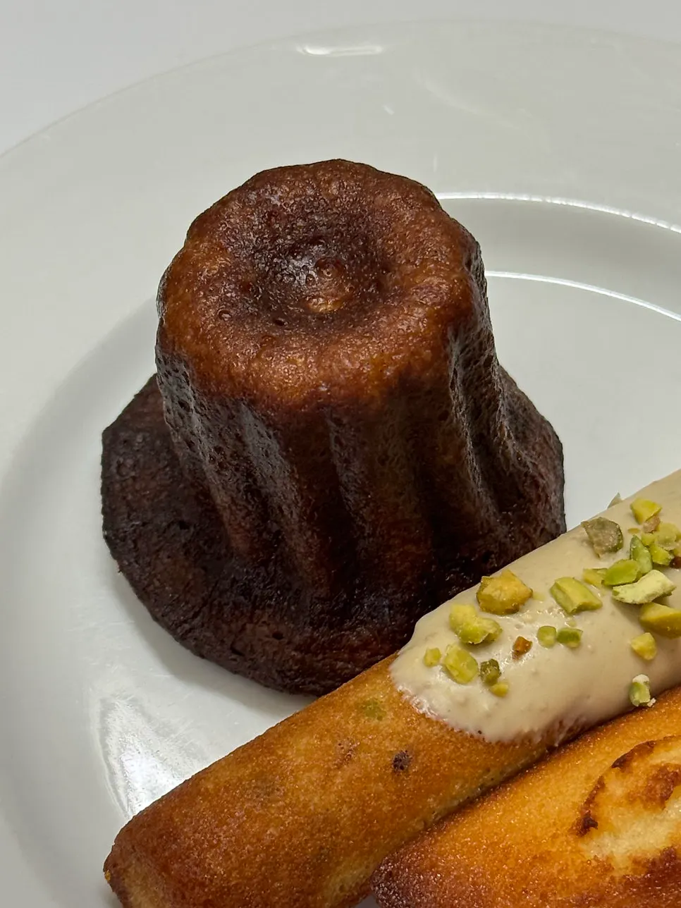 Close-up of the vanilla canelé and plain financier