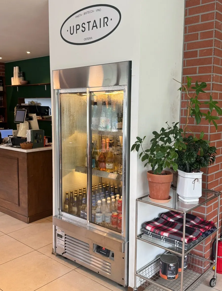 Fridge stocked with wine and drinks at Upstairs Kitchen