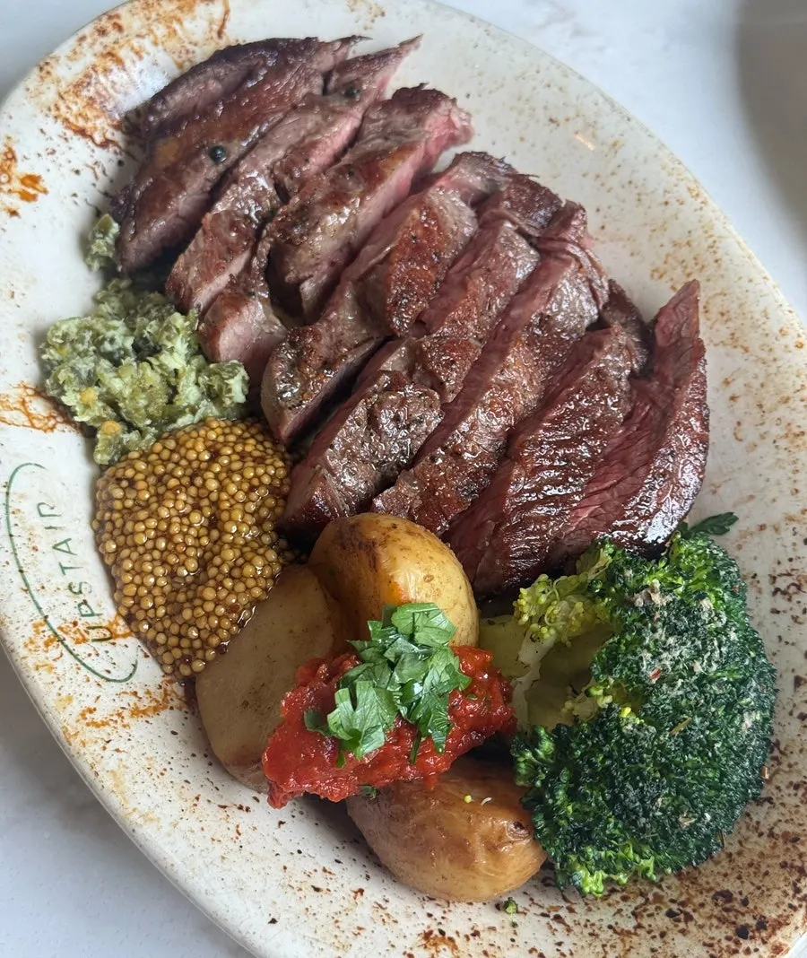 Upstairs Kitchen's sirloin steak plated with sides