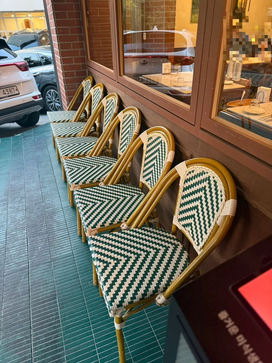 Exterior wall with a green awning and yellow lighting