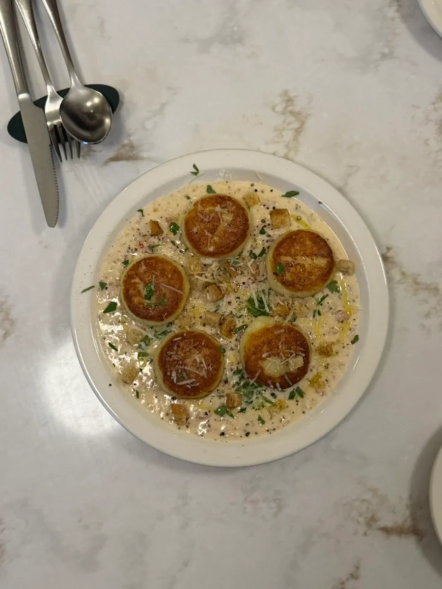 A plate of bacon cream gnocchi in cream sauce