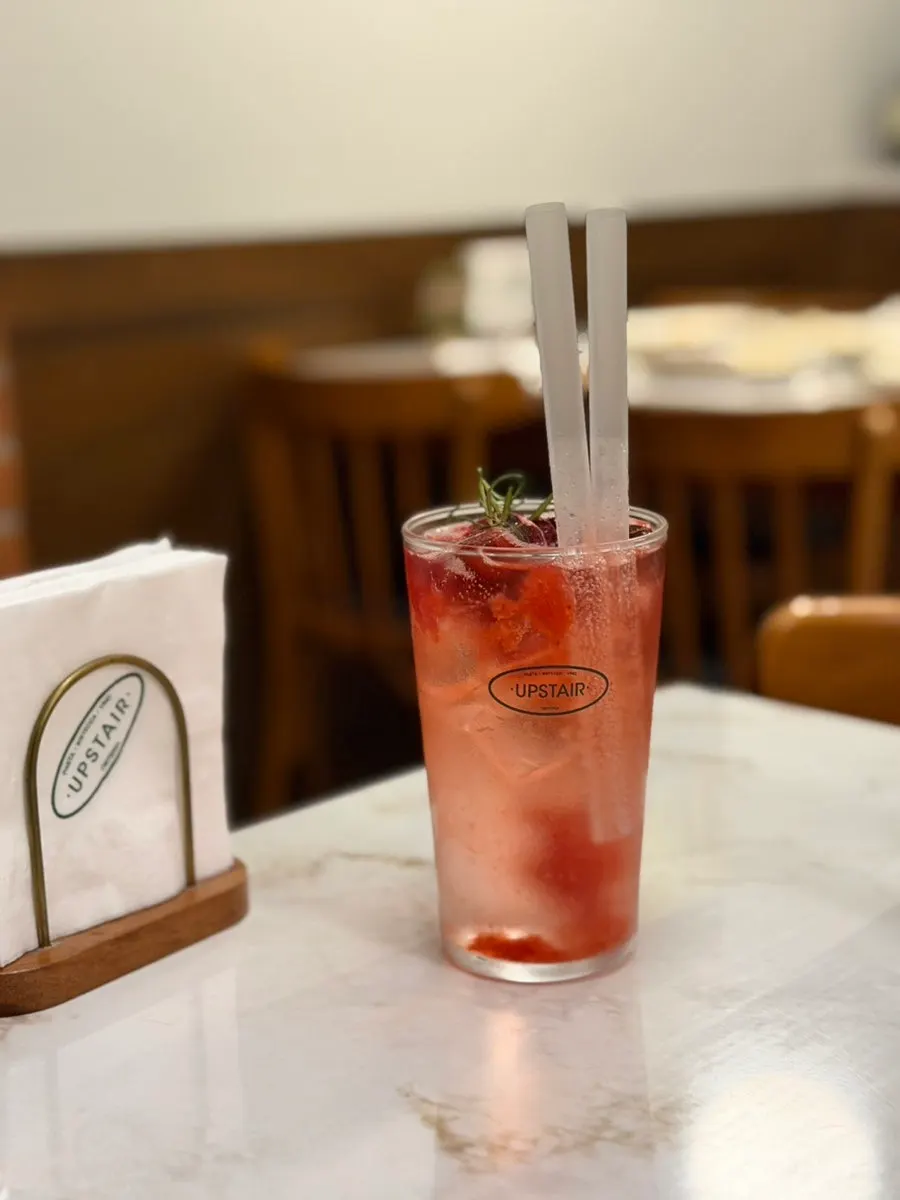 A glass of triple berry ade with berries
