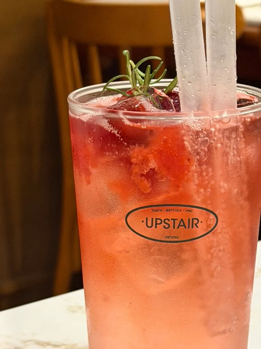 Close-up of the ade glass showing carbonation and berries