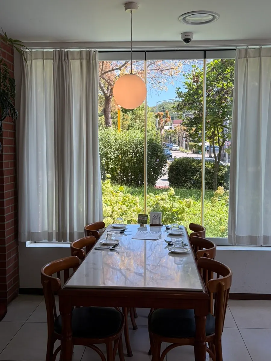 Sunny dining hall seating at Upstairs Kitchen