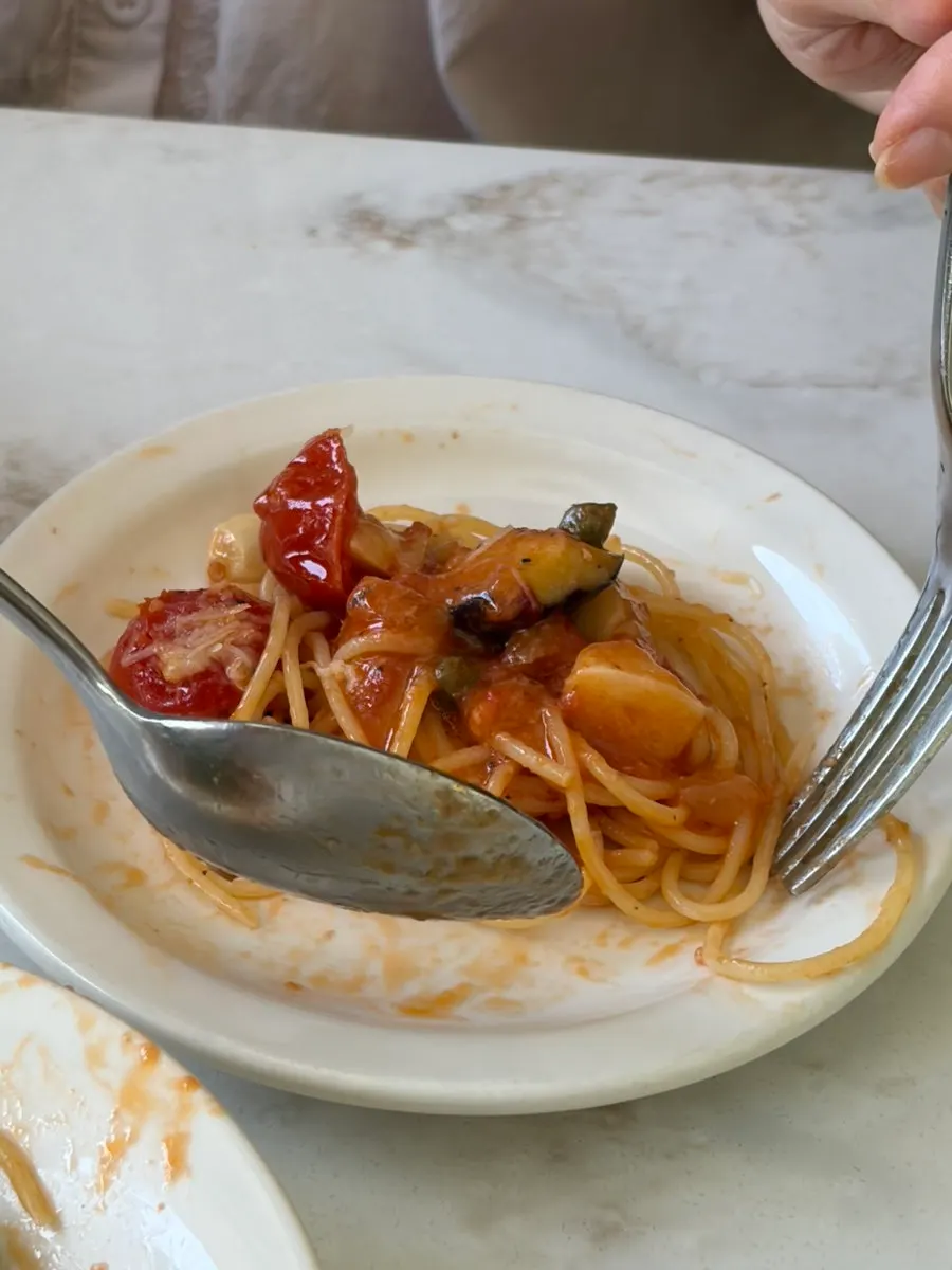 Tomato pasta twirled on a fork