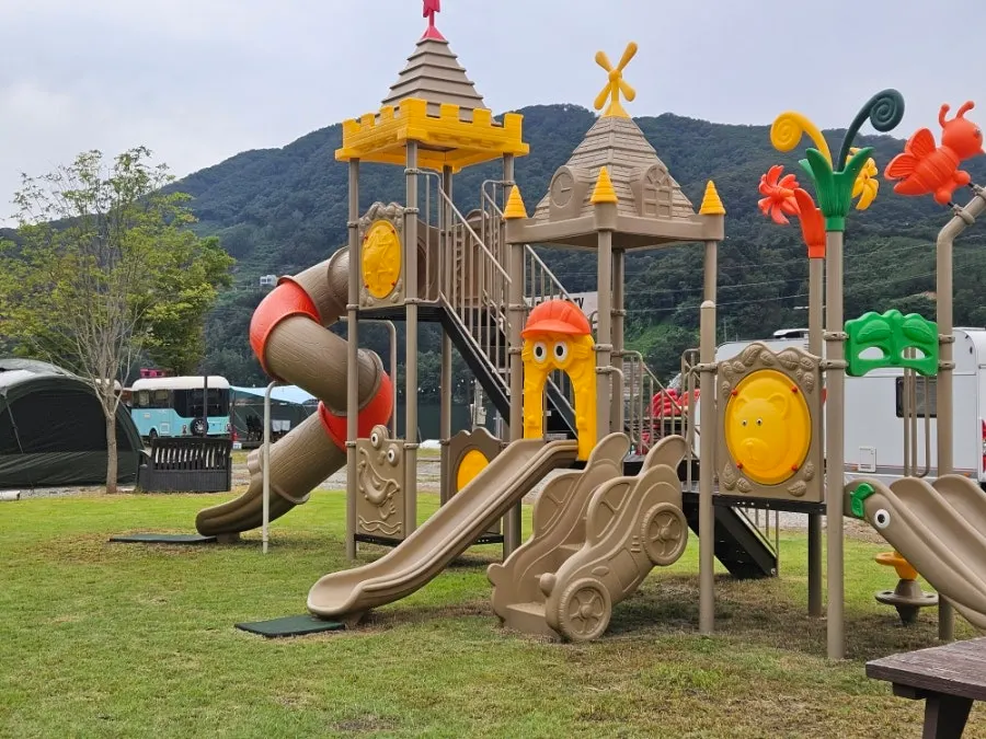 Playground with slide and swings on the grass