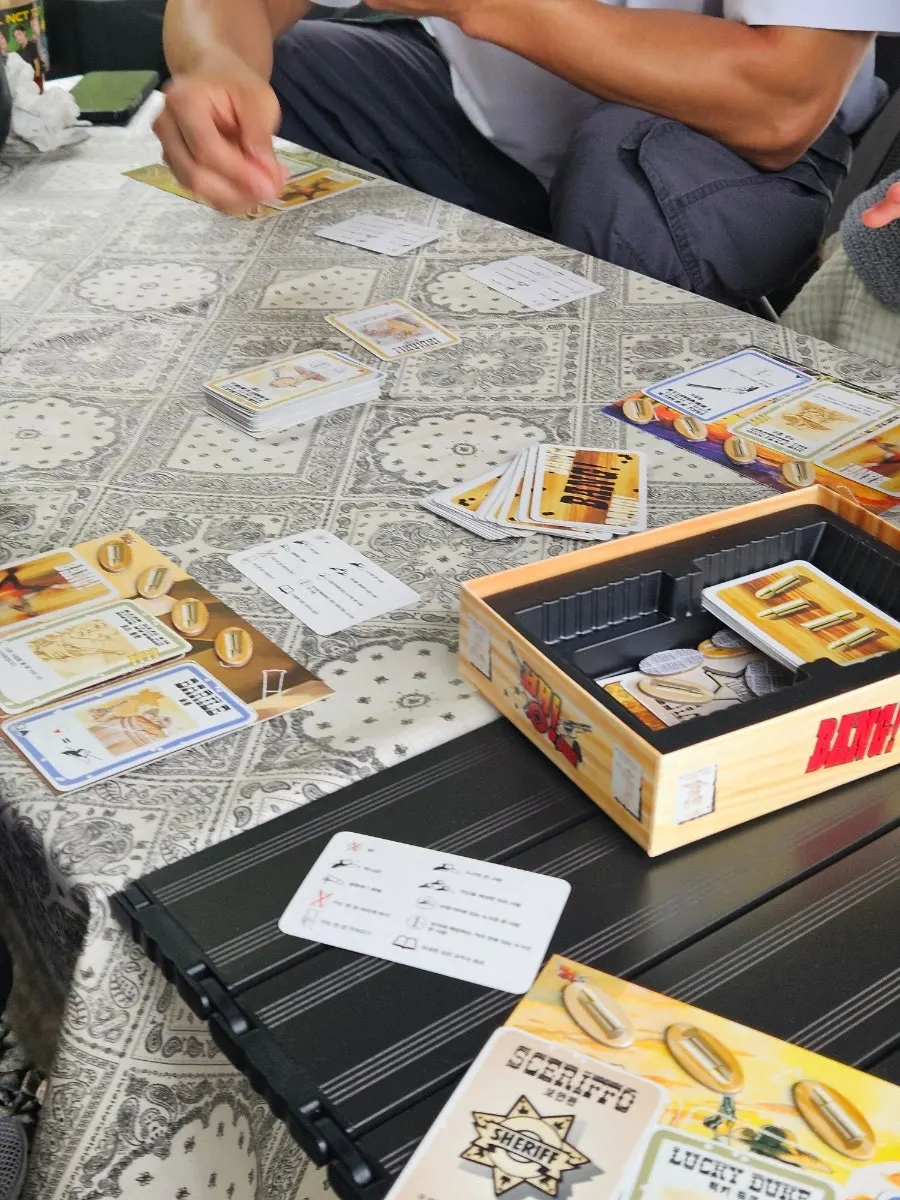 Table under a tarp with board games and drinks