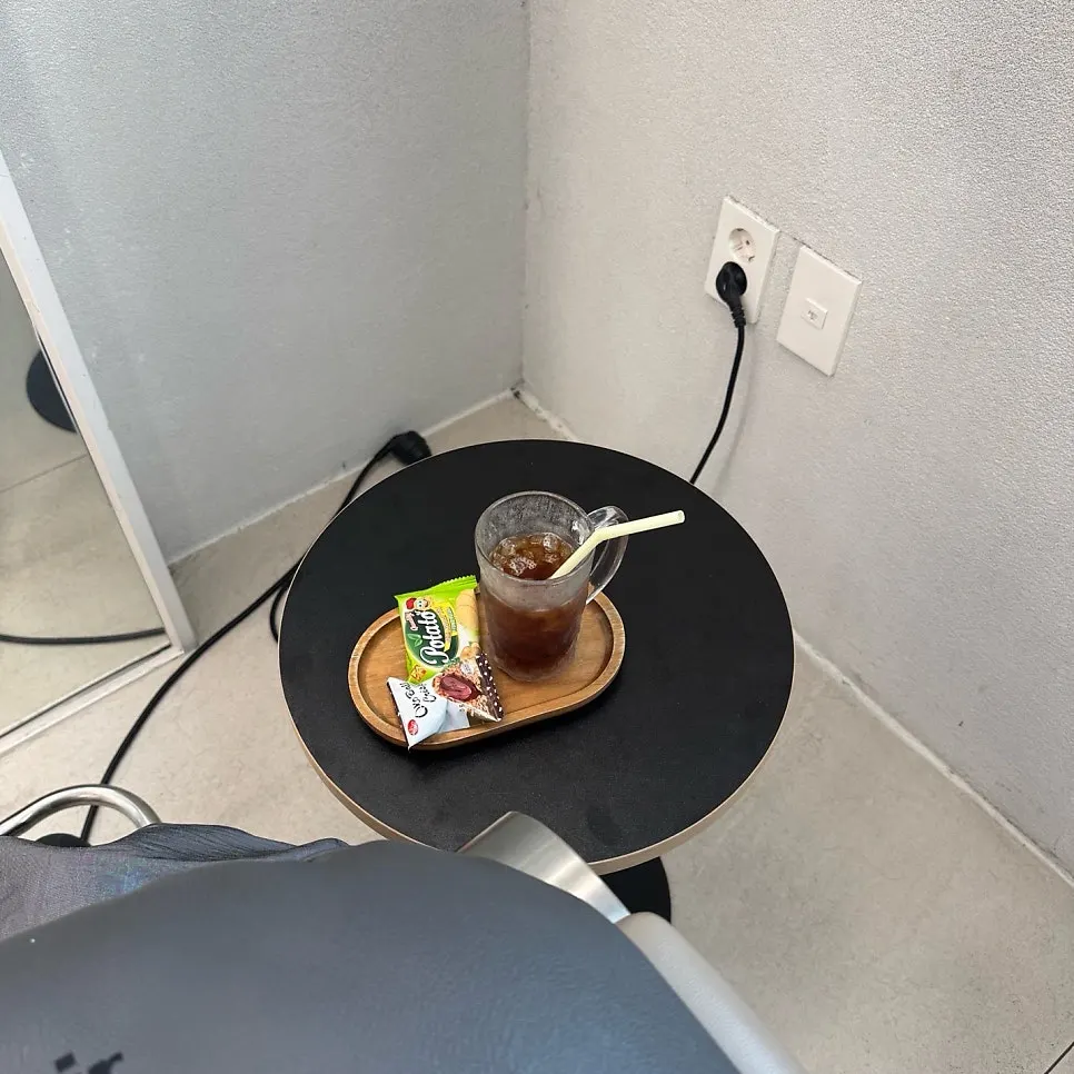 Drink and snacks placed on the side table by the treatment chair