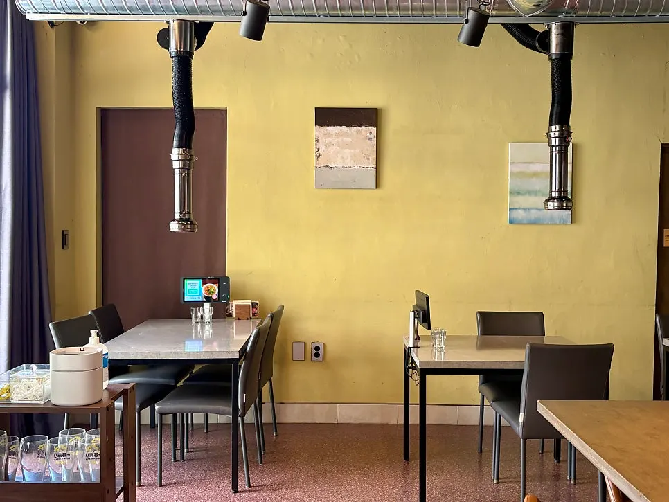 Interior of Utan with 4-person tables and bar seating
