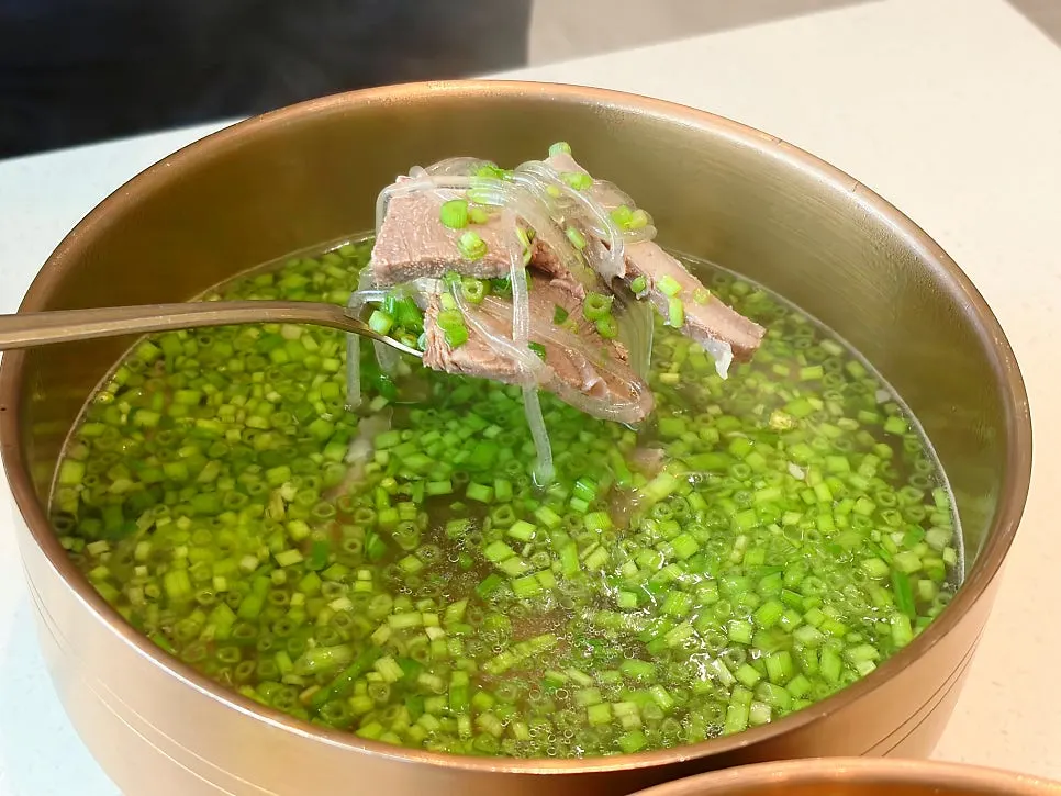 Korean beef gomtang loaded with minari (watercress)