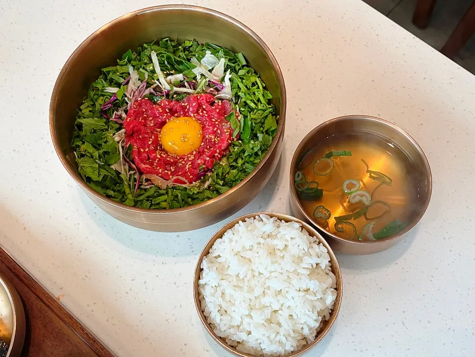Broth served alongside Korean beef yukhoe bibimbap