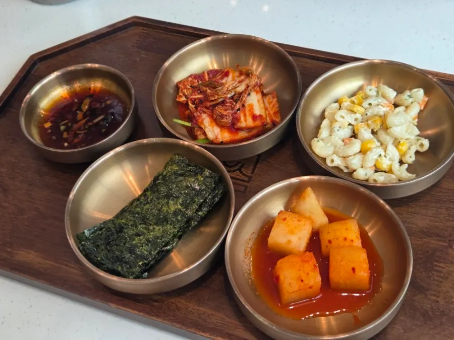 Side dish spread including kimchi at Useum Pangyo Branch