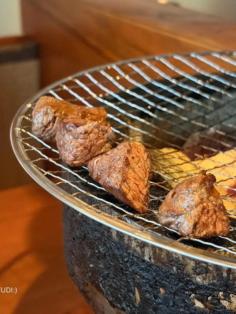 Chef placing meat on the grill