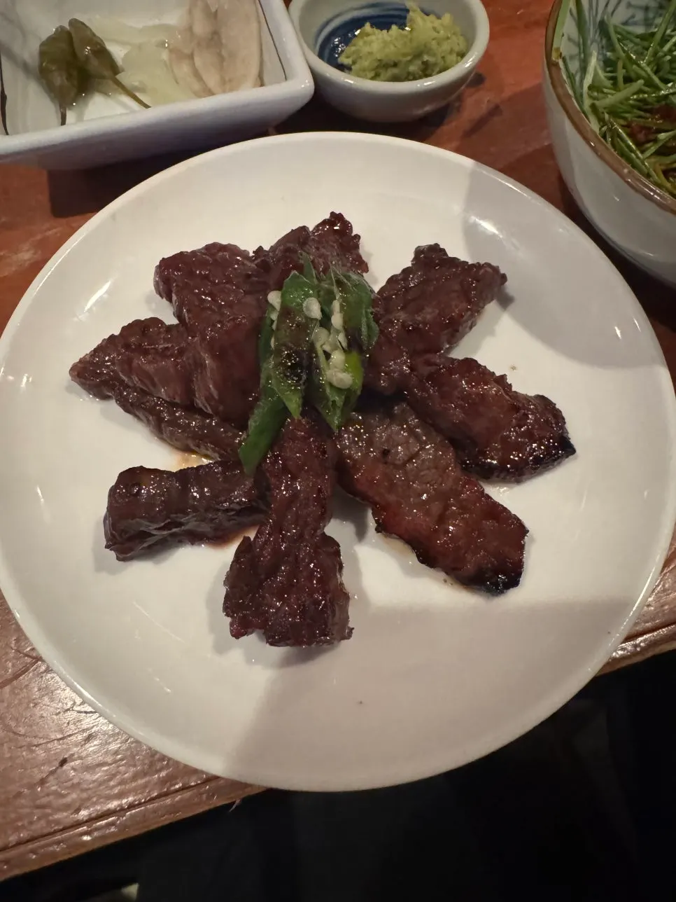 Thin red meat glazed with soy sauce, grilled over charcoal