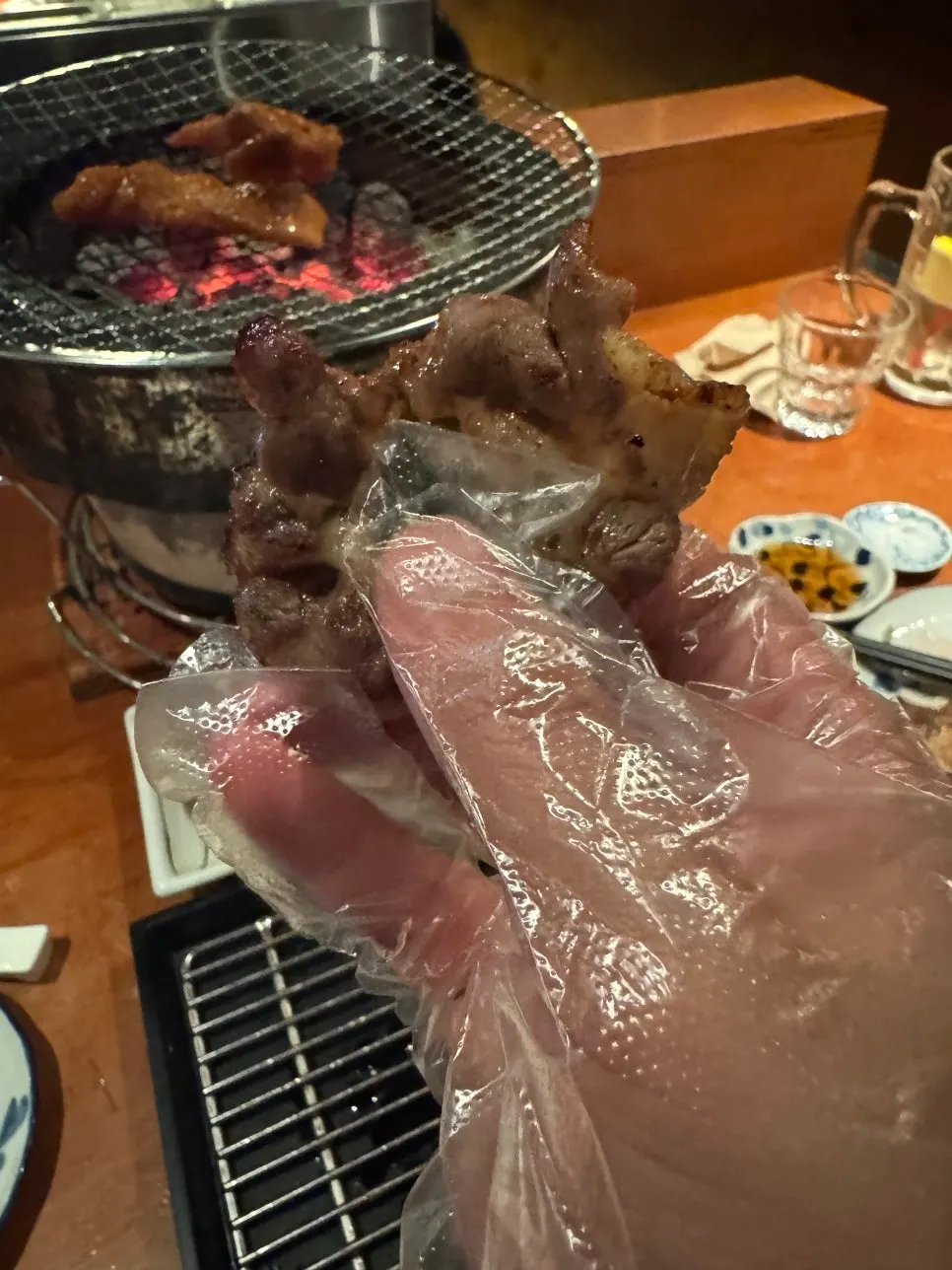 Grilled tail and soy-glazed beef stomach lining over charcoal
