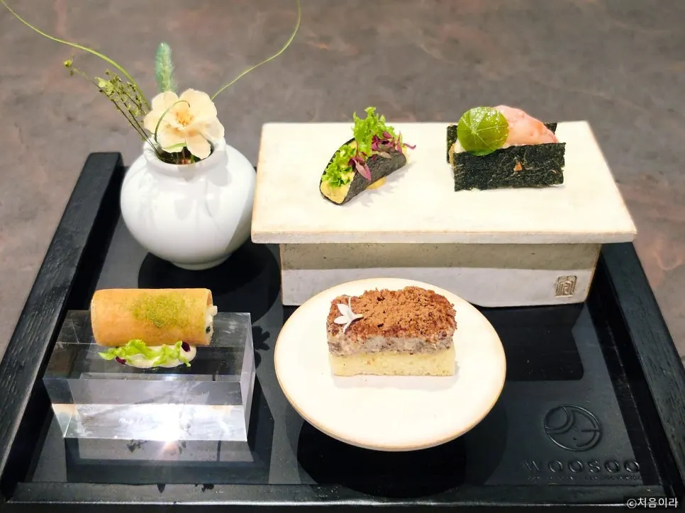 Four bite-size dishes arranged on one plate