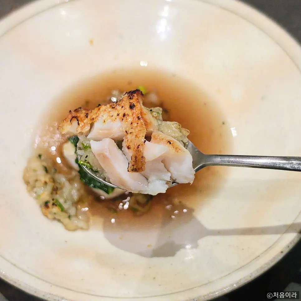 Grilled red tilefish and neungi mushroom broth over barley wild herb rice
