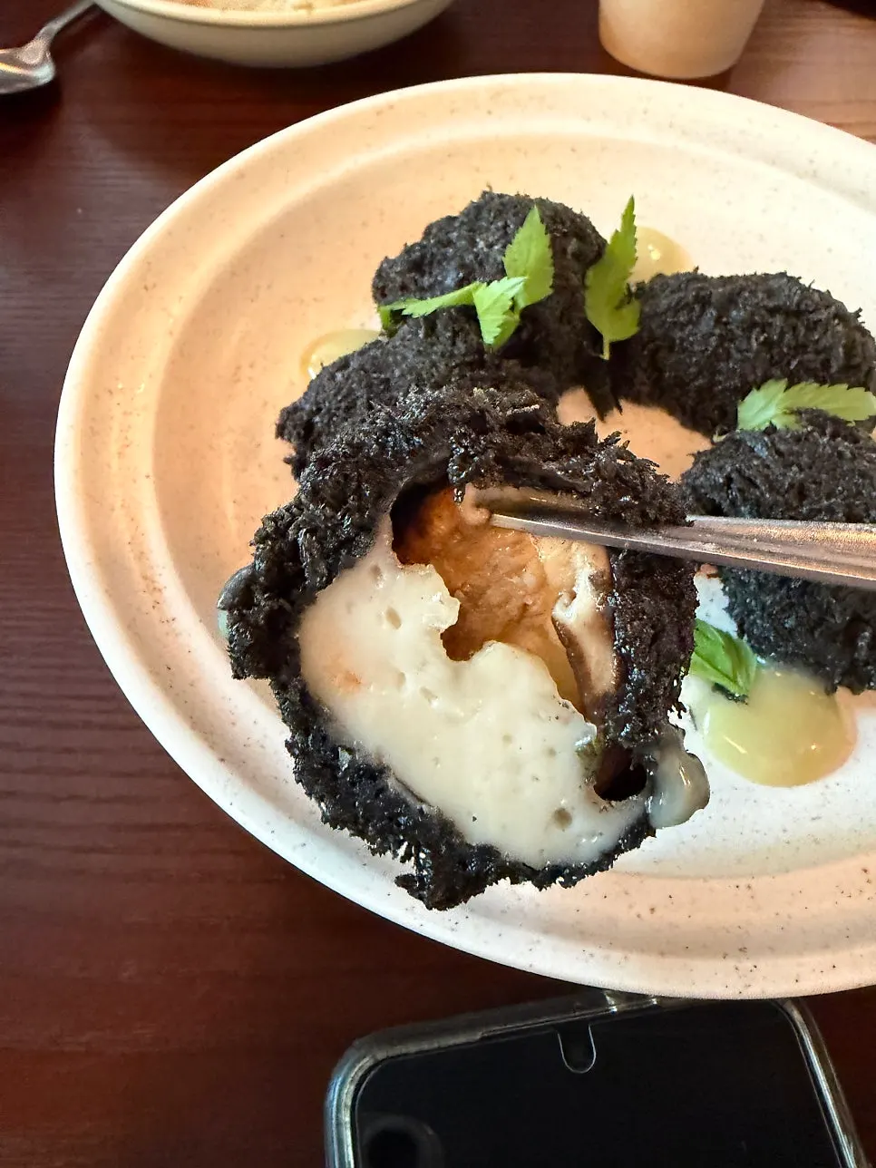 Close-up of shrimp-stuffed shiitake ink fritters