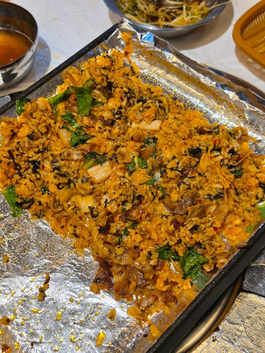 Meat and grilled kimchi chopped up in preparation for self-serve fried rice