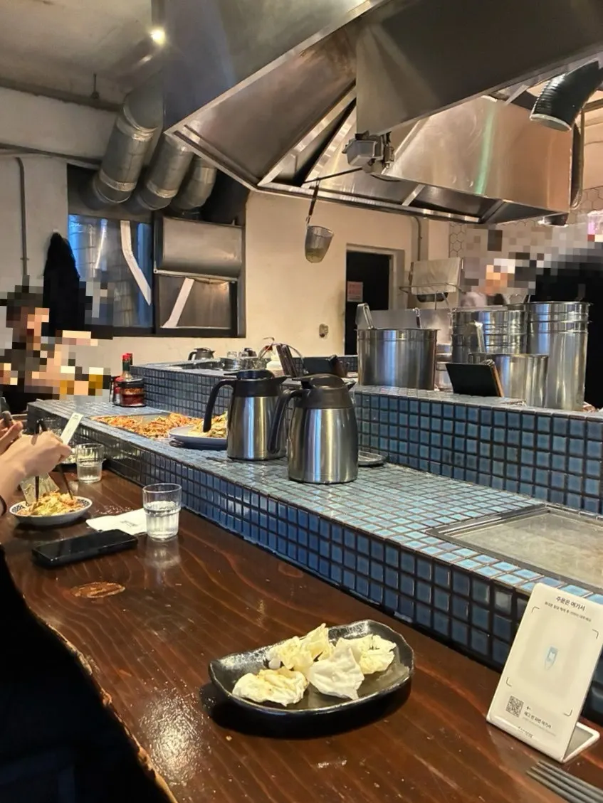 Interior open kitchen and bar table at UWA Hongdae Main Branch