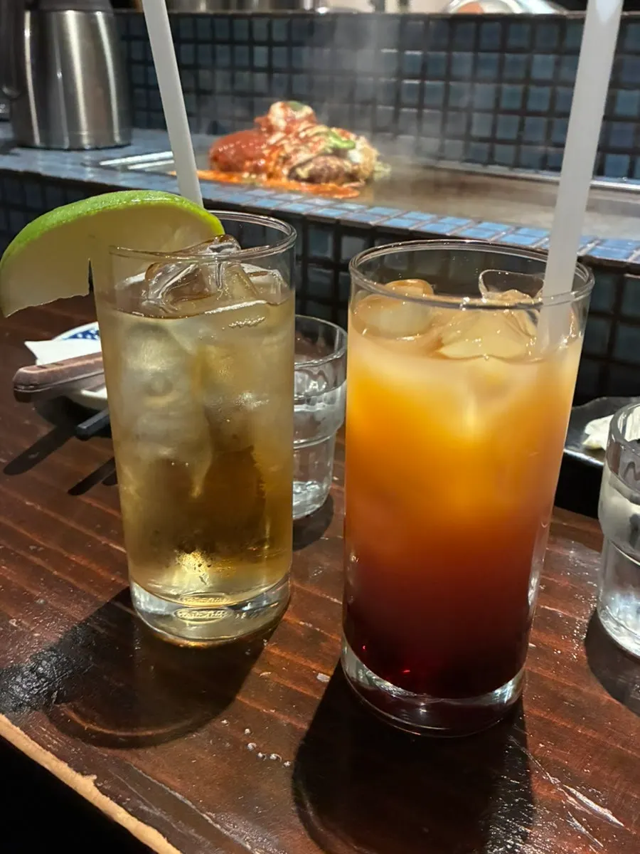 Two glasses of ginger & lime highball and cassis orange