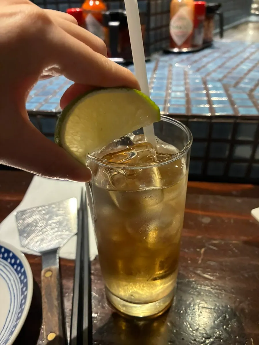 A highball with lime squeezed in