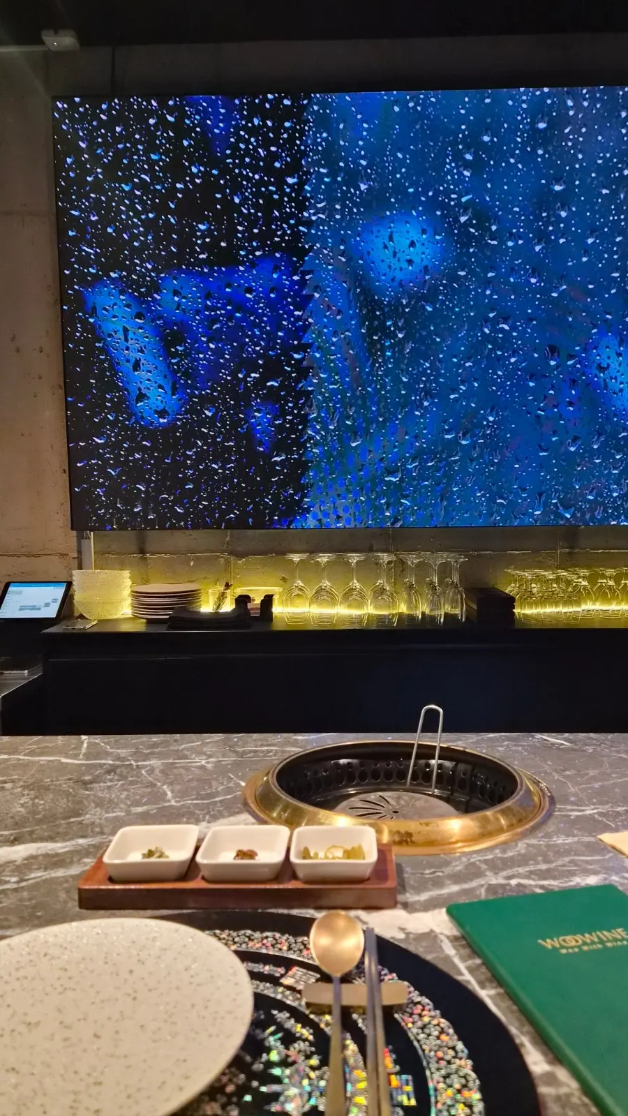 Bar seats and individual tabletop grills inside Woowine