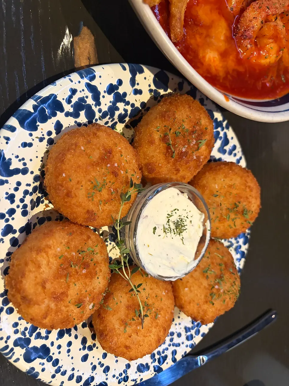 Cross-section of a croquette dipped in sauce