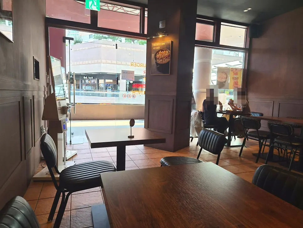 Base Burger hall seating under soft lighting