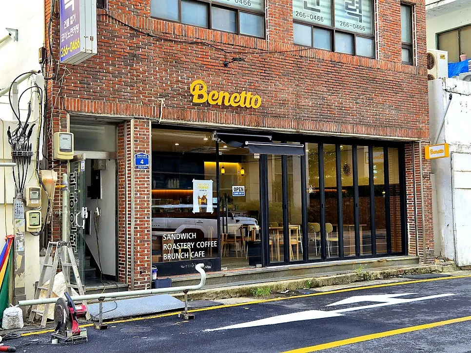 Exterior of Benetto's red-brick building across from City Hall's north gate