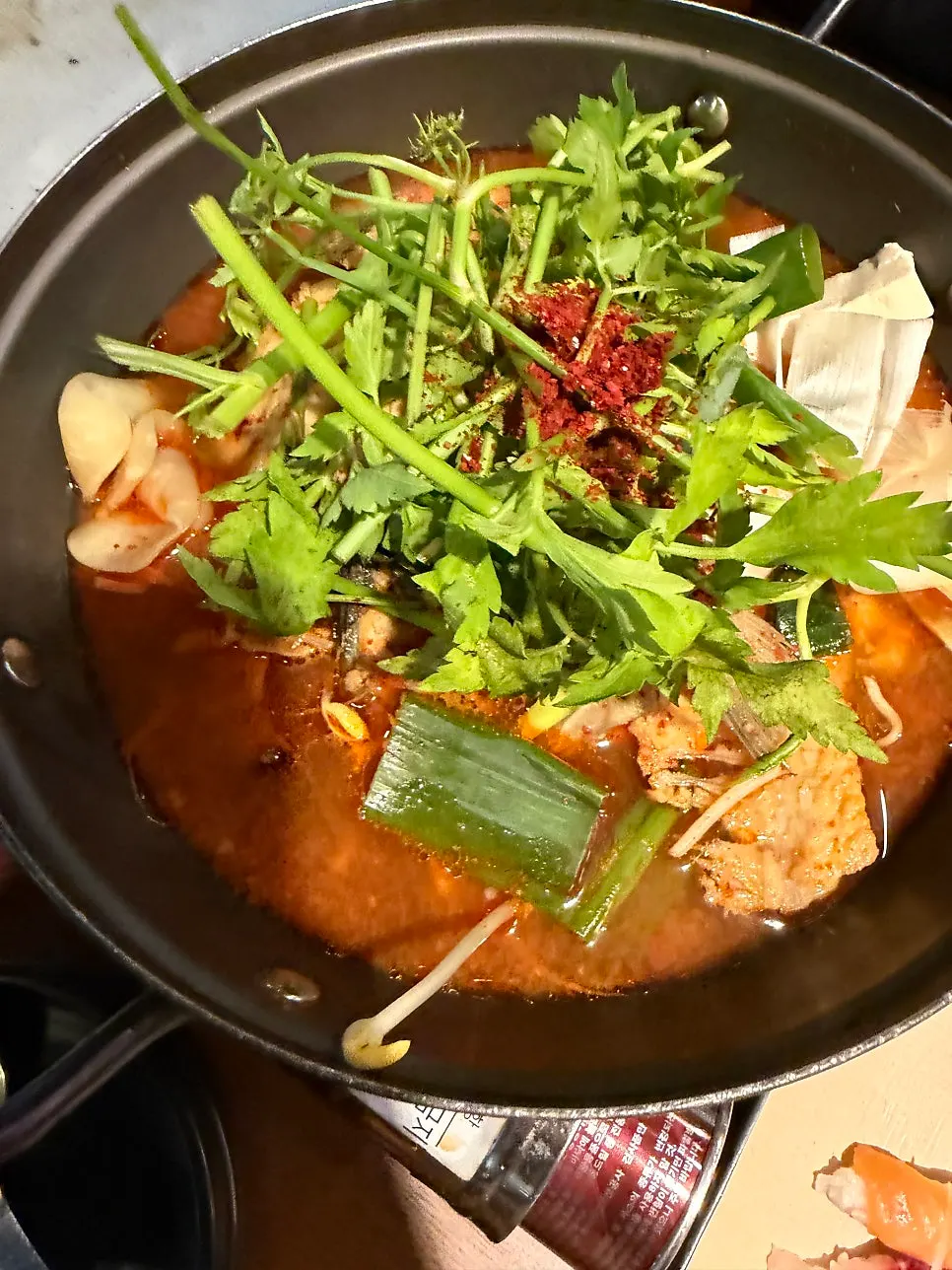 A pot of fish bone stew on the burner