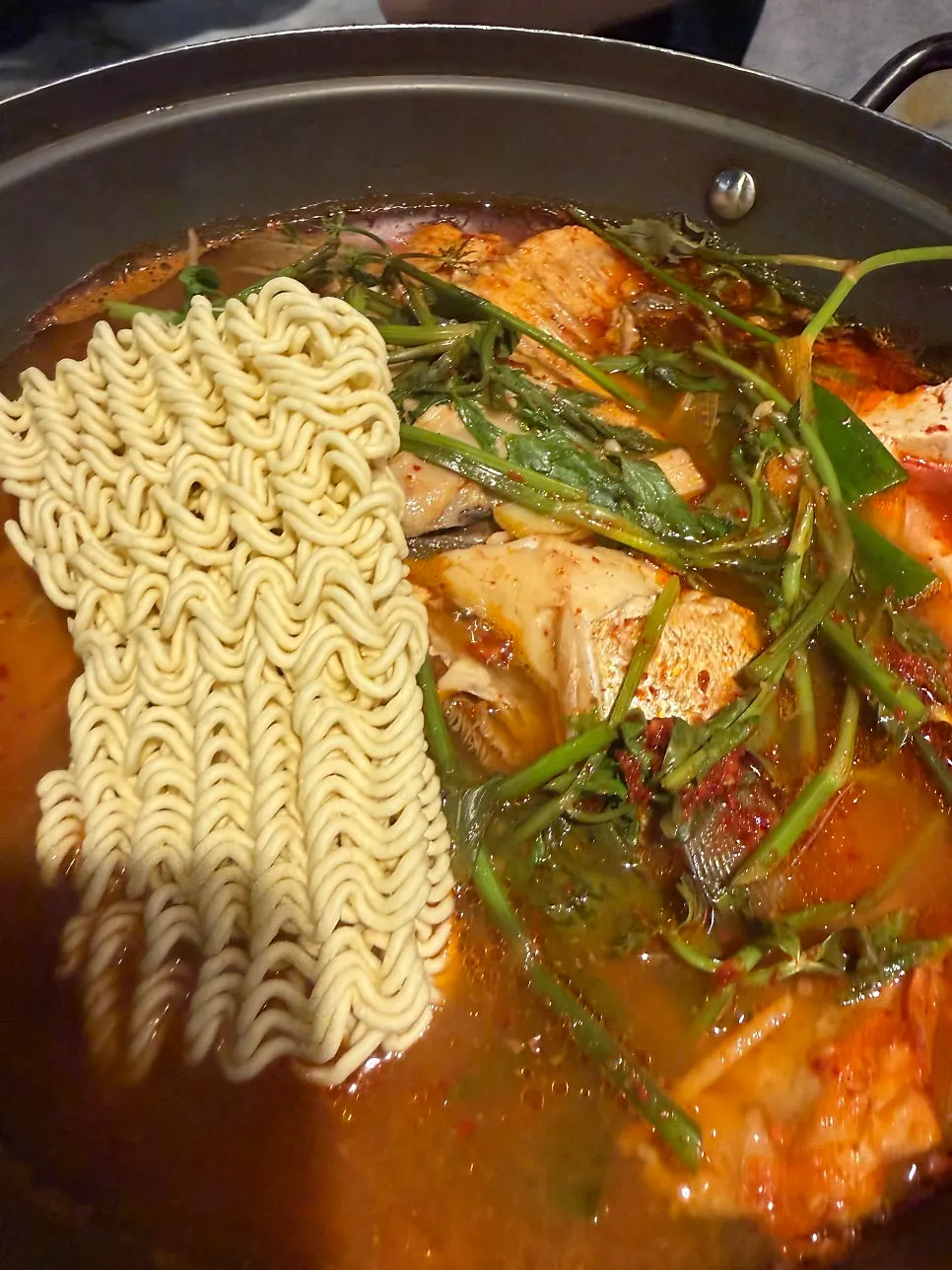 A bowl of the finishing spicy fish stew from the lunch special