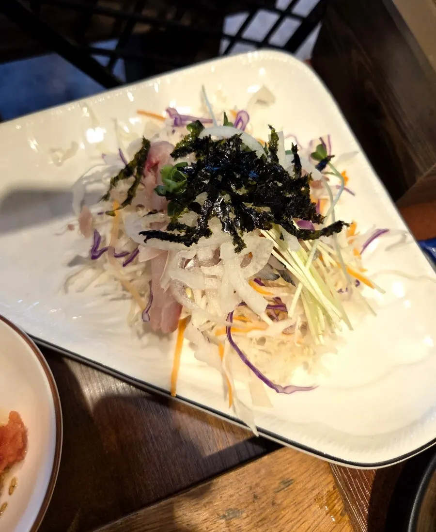 Complimentary salad and seasoned raw fish salad