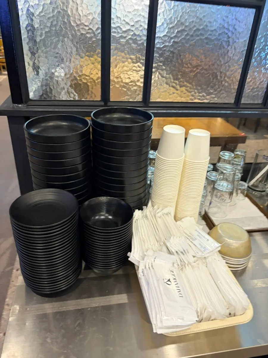 Self-serve bar with side plates, paper cups, and soju cups neatly arranged