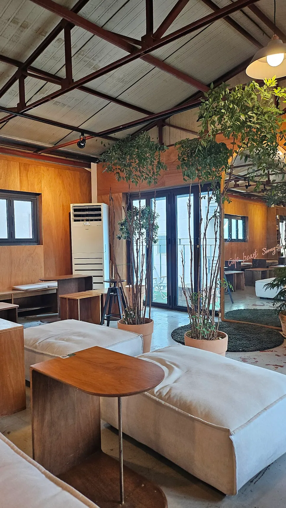 Café table area divided by green plants