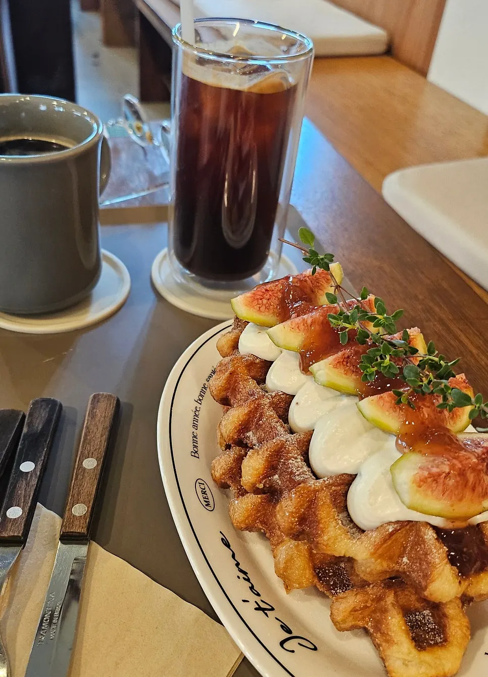 Fig Greek croffle and coffee order set out on the table