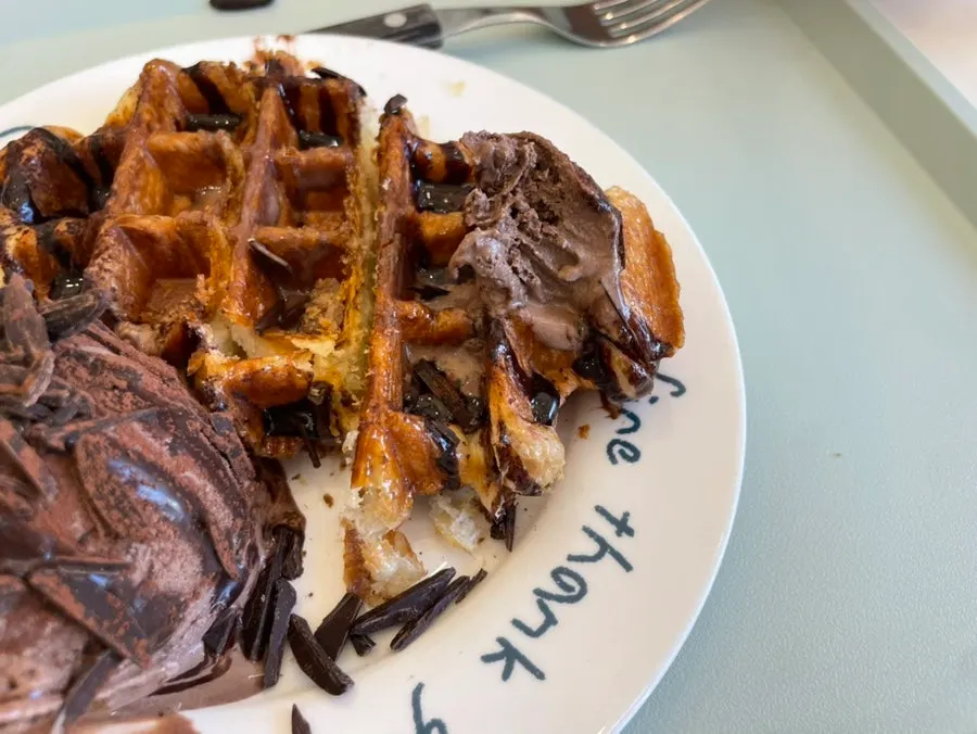 A piece of croffle topped with chewy chocolate ice cream