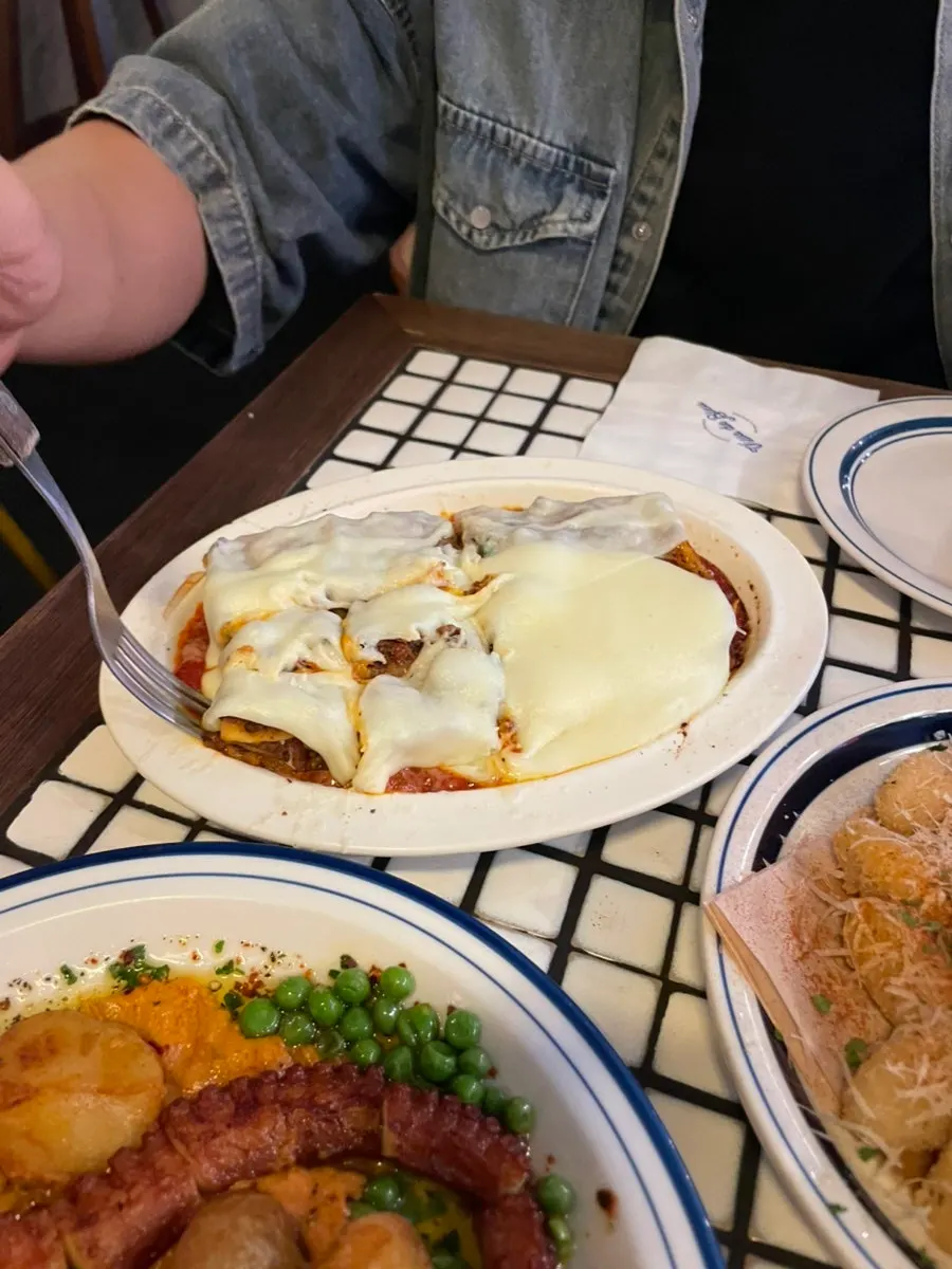 Aligot cheese lasagna with a long cheese pull