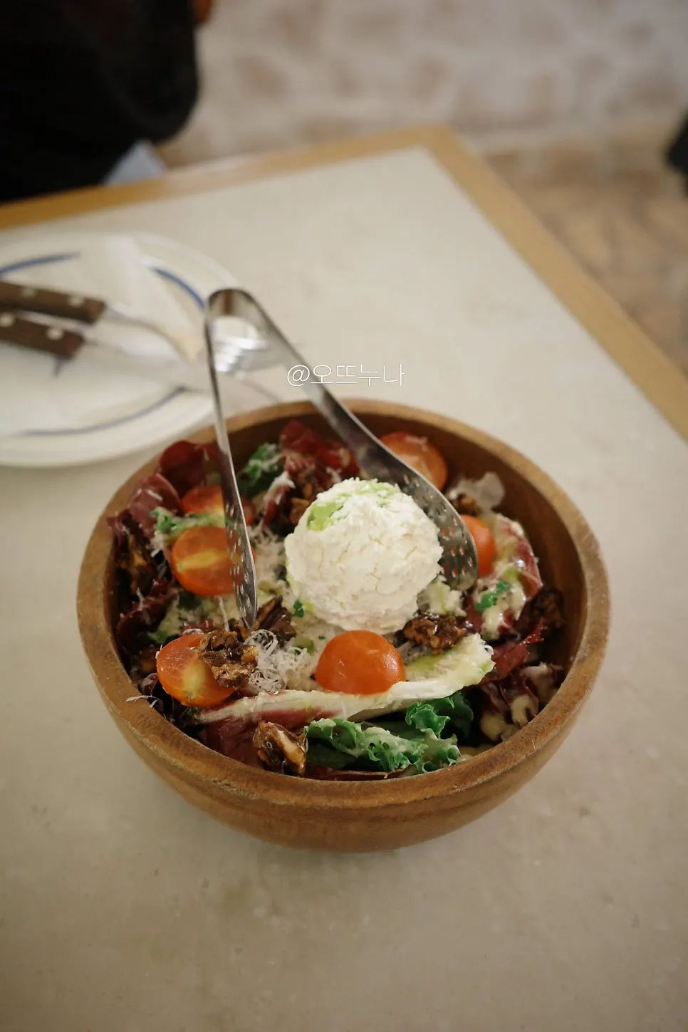 House ricotta salad topped with ricotta cheese